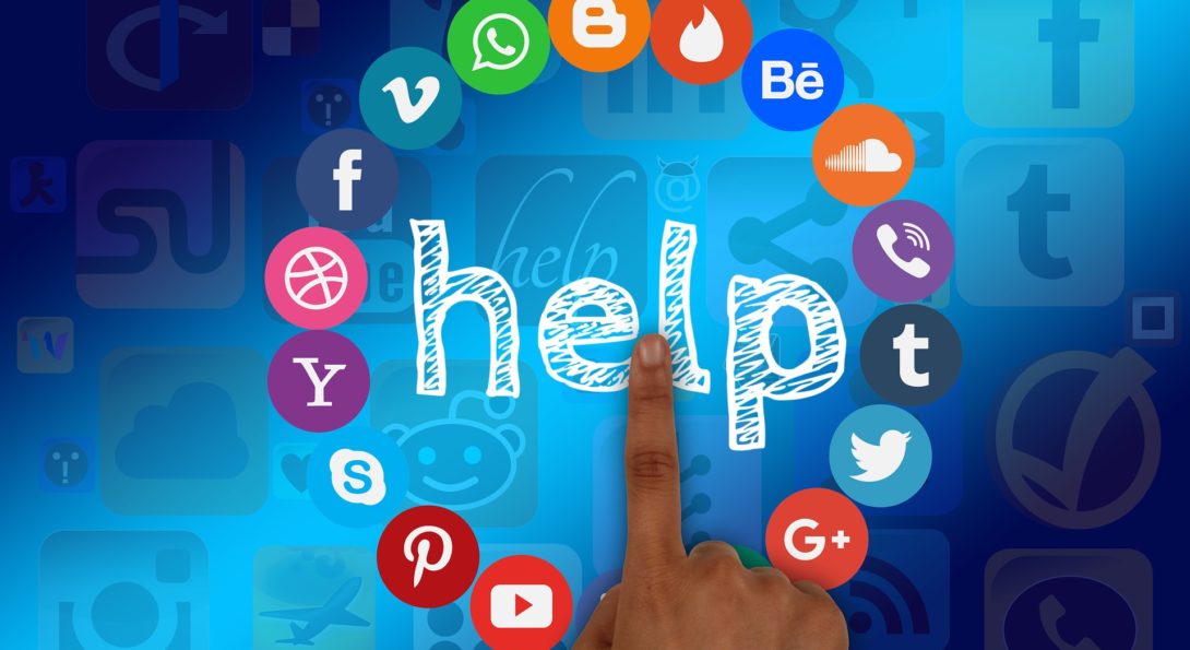 finger pointing to word help surrounded by social media icons