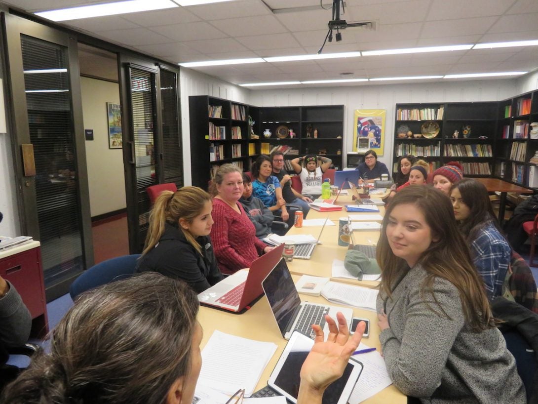 Graduate seminar with students engaged in discussion with instructor